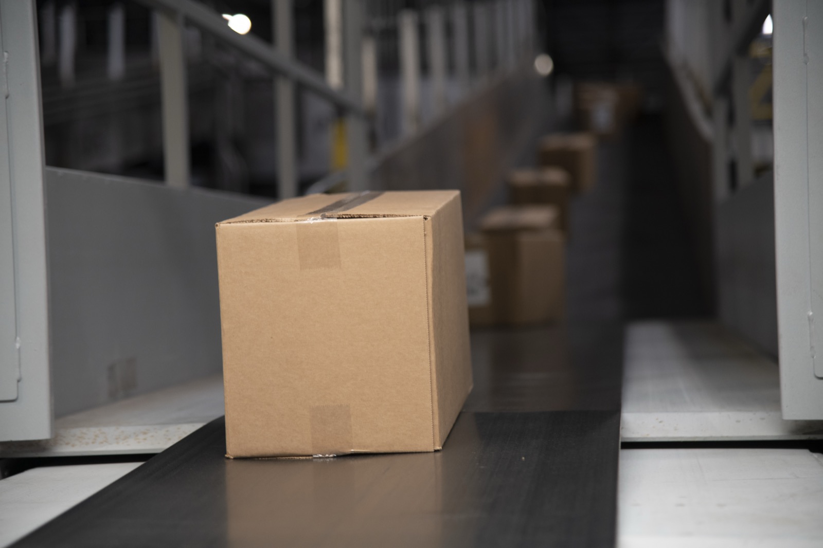 Packages moving along a distribution center conveyor belt