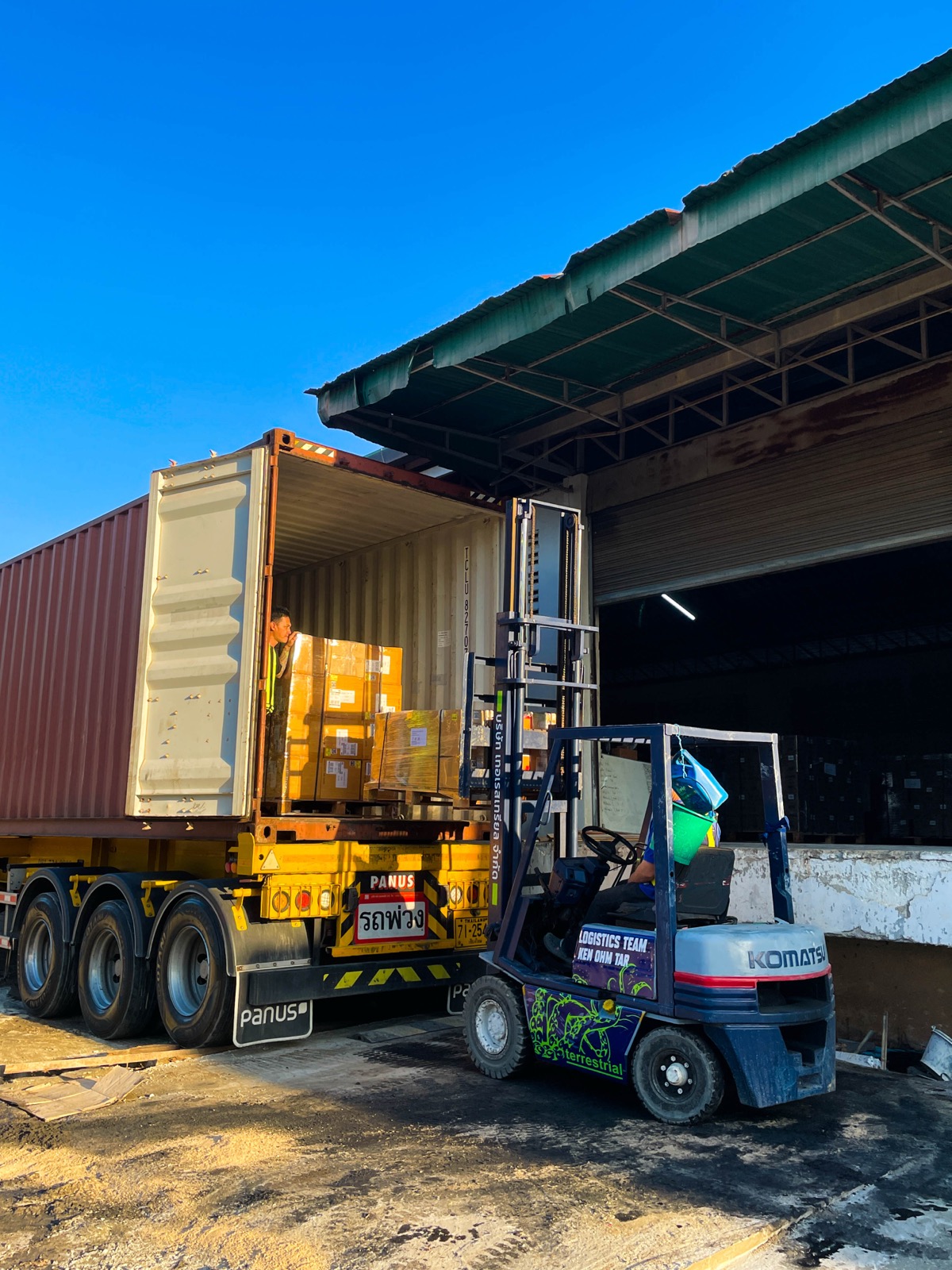Forklift loading a container in a warehouse